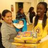 A student Volunteer giving toys  to a family