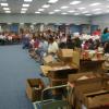 Recipients listening to inspirational message before grocery distribution.