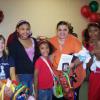 A happy familty displays their back-packs and school supplies.